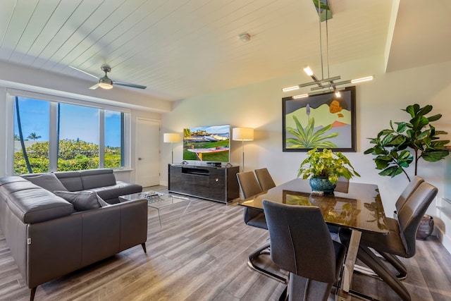 living room with ceiling fan with notable chandelier, hardwood / wood-style flooring, and wood ceiling