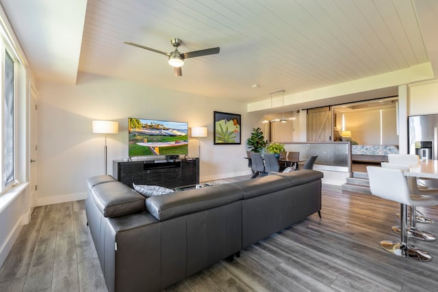 living room featuring wood ceiling, dark hardwood / wood-style flooring, and ceiling fan