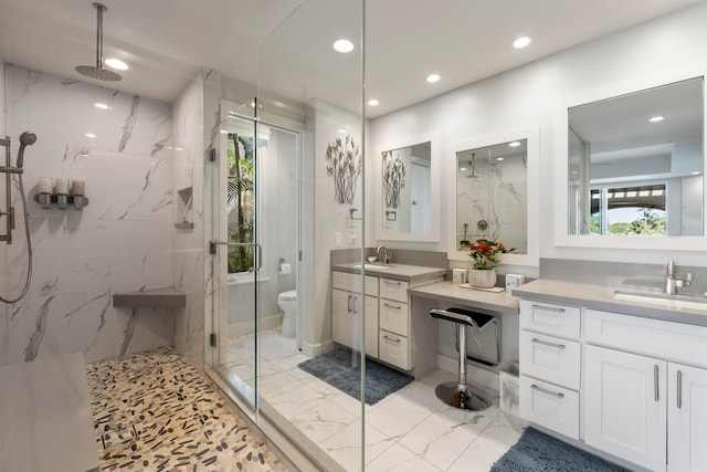 bathroom featuring vanity, a shower with shower door, toilet, and tile flooring