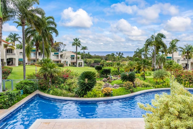 view of pool featuring a lawn