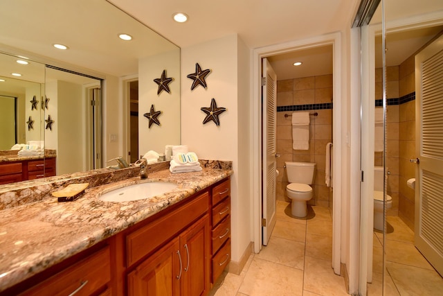 bathroom featuring vanity, toilet, and tile flooring