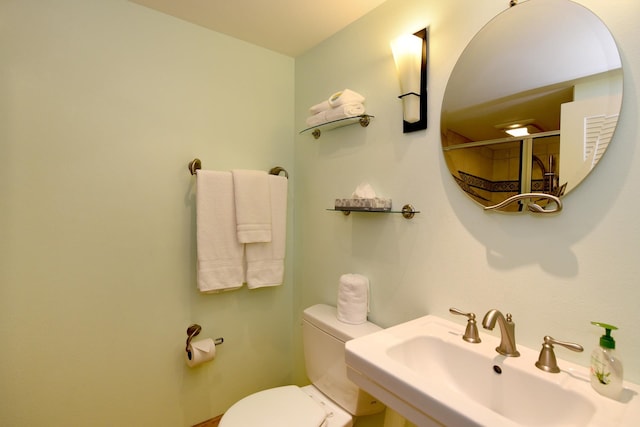 bathroom featuring sink and toilet