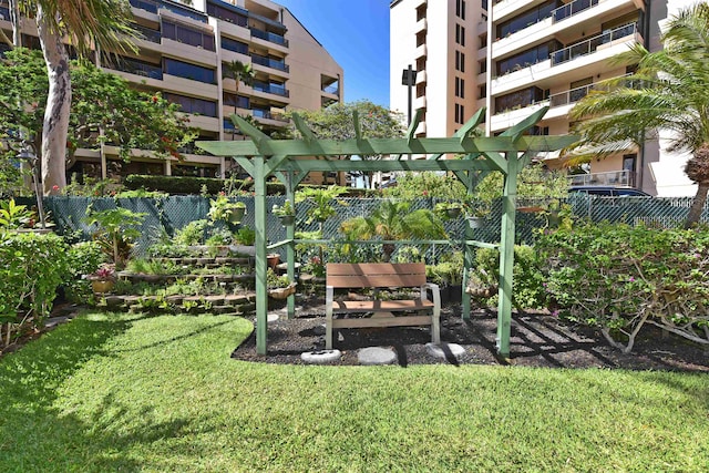 view of yard with a balcony and a pergola