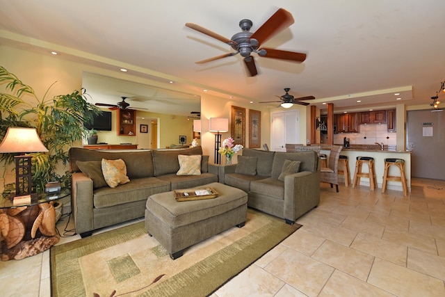 tiled living room with ceiling fan