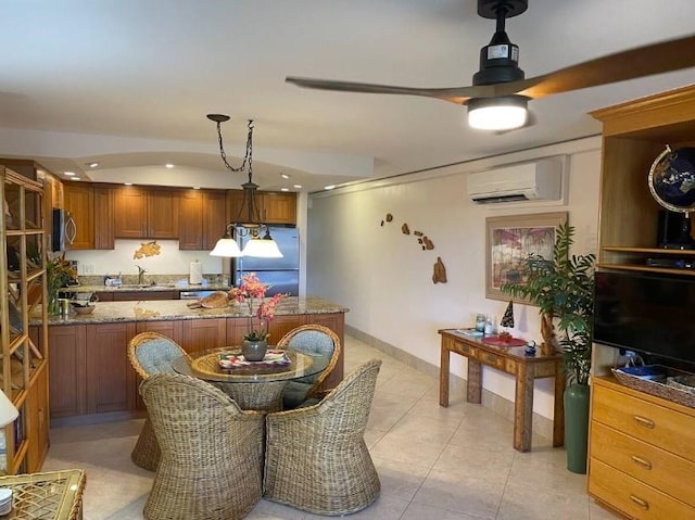 kitchen with sink, stainless steel appliances, light tile patterned flooring, decorative light fixtures, and an AC wall unit