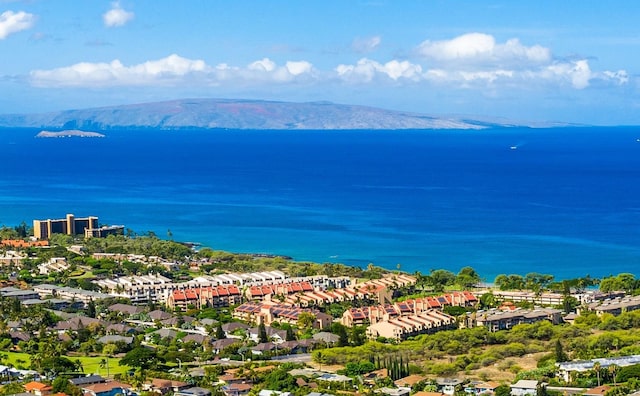 drone / aerial view featuring a water and mountain view