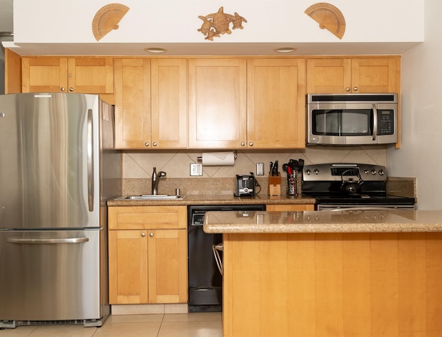 kitchen with sink, light tile patterned flooring, stainless steel appliances, and light brown cabinets