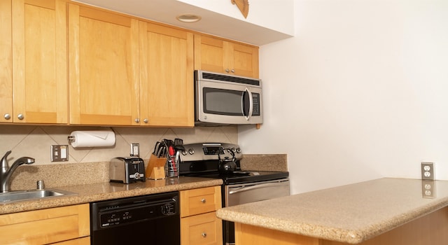 kitchen featuring stainless steel appliances, sink, light brown cabinetry, and backsplash