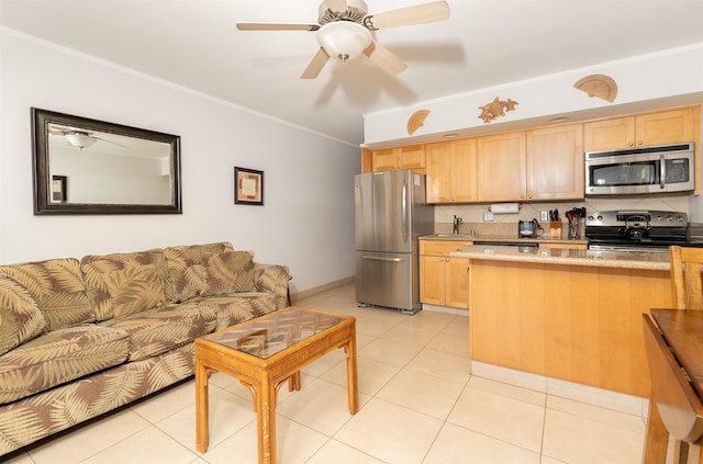 kitchen featuring light tile patterned flooring, appliances with stainless steel finishes, sink, and light brown cabinets