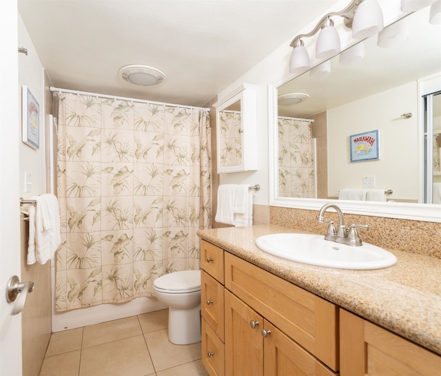 bathroom featuring vanity, toilet, and tile patterned floors