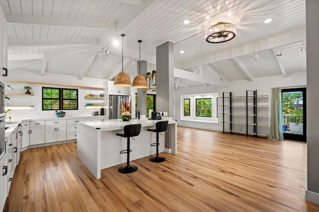 kitchen featuring freestanding refrigerator, open shelves, wooden ceiling, open floor plan, and light wood-style floors