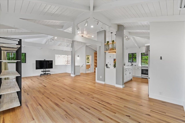 unfurnished living room with light wood-type flooring, baseboards, and wooden ceiling