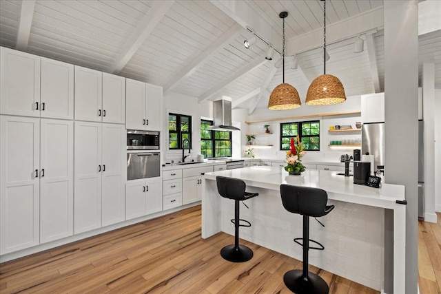 kitchen with open shelves, stainless steel appliances, a sink, extractor fan, and light countertops