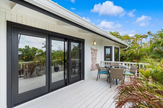wooden terrace featuring outdoor dining space