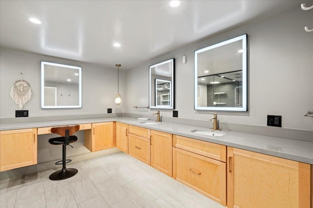 kitchen with a sink, light brown cabinetry, recessed lighting, and light countertops