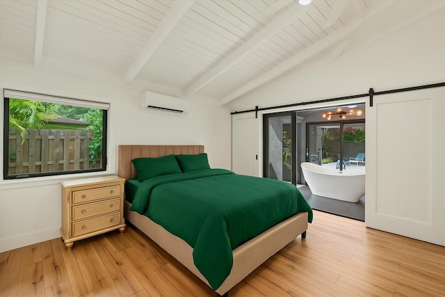 bedroom with a barn door, access to exterior, light wood-type flooring, and an AC wall unit