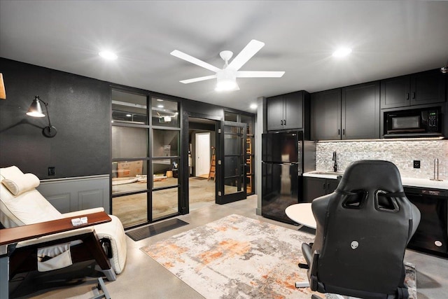 office area with concrete floors, ceiling fan, a sink, recessed lighting, and a decorative wall