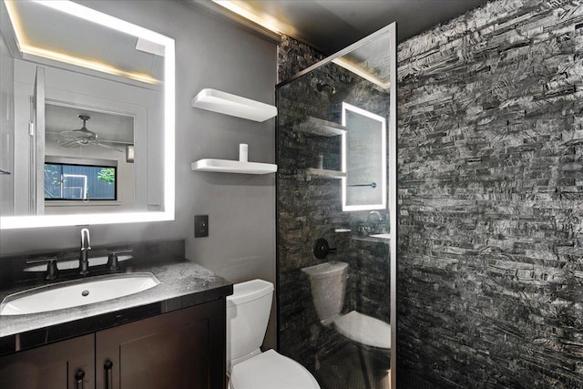 full bath featuring a shower stall, toilet, vanity, and ceiling fan