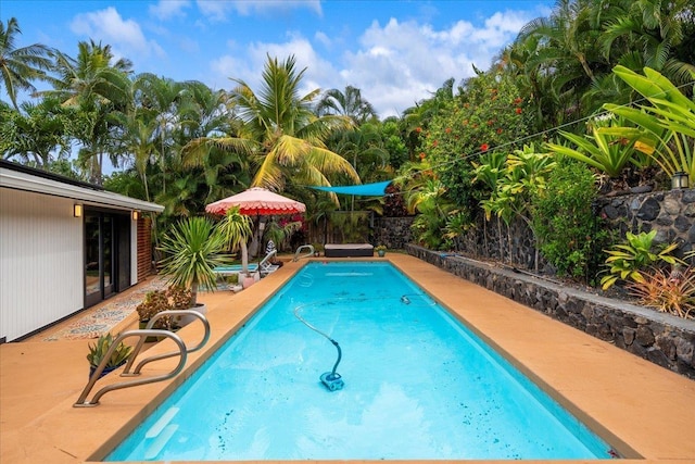 outdoor pool featuring a fenced backyard and a patio