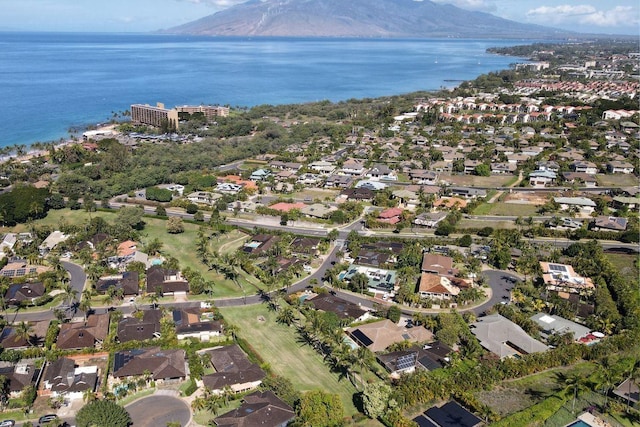 aerial view of property and surrounding area with a water and mountain view and nearby suburban area