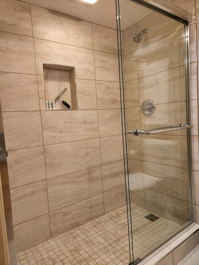 bathroom with a shower with shower door