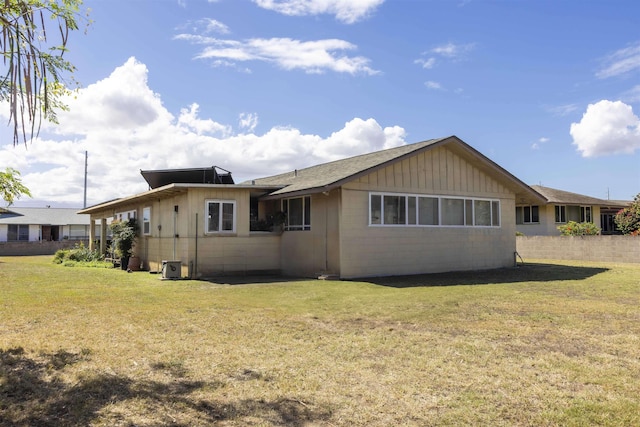 rear view of house with a lawn