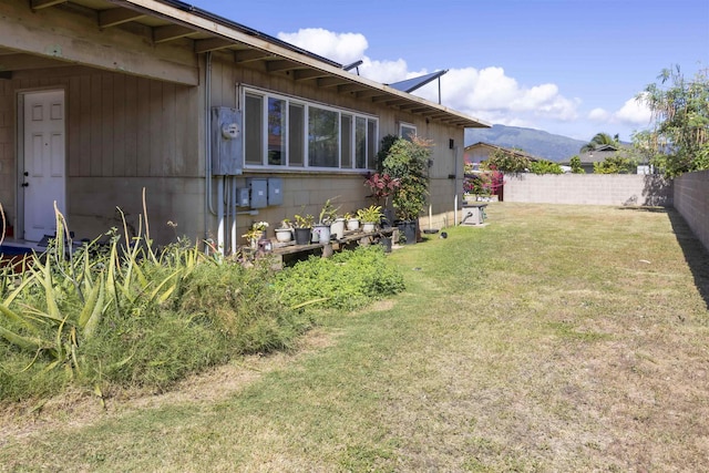 view of yard featuring a mountain view and fence