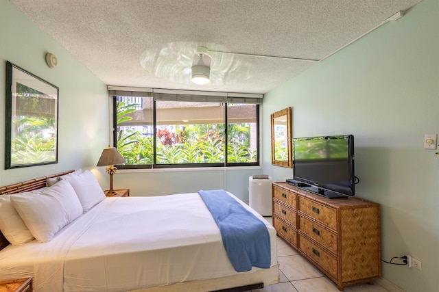 tiled bedroom featuring a textured ceiling