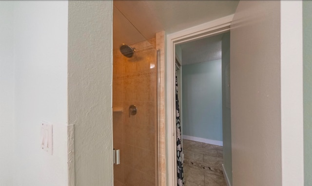 bathroom with tile patterned floors and a shower with shower door