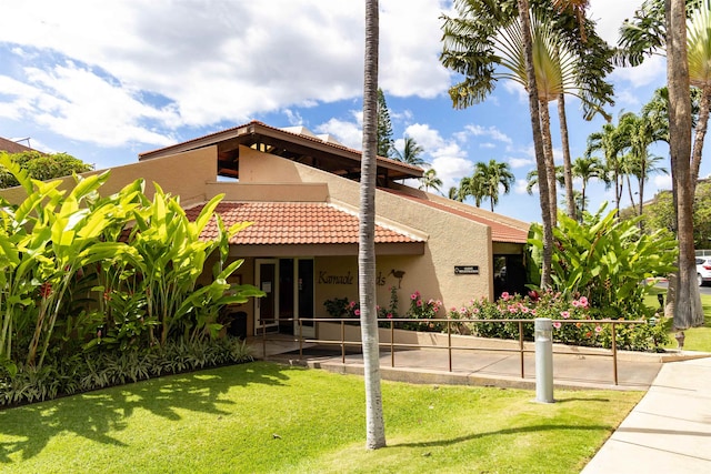 mediterranean / spanish-style house with a front yard