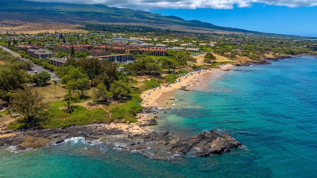 birds eye view of property with a water and mountain view