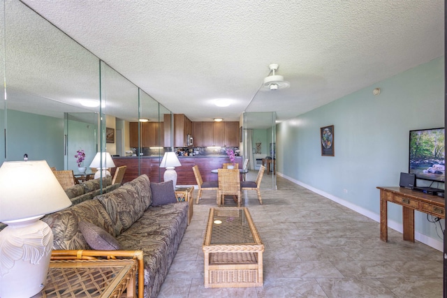 living room featuring light tile patterned floors and a textured ceiling