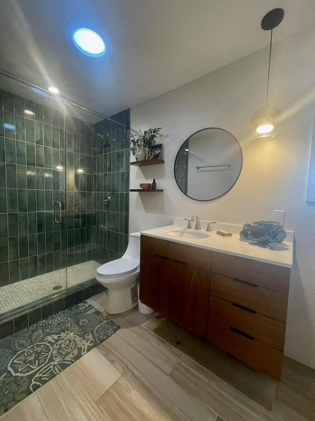 full bath with toilet, a shower stall, and vanity