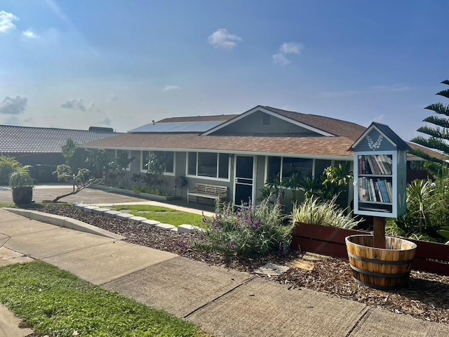 rear view of house with a shingled roof