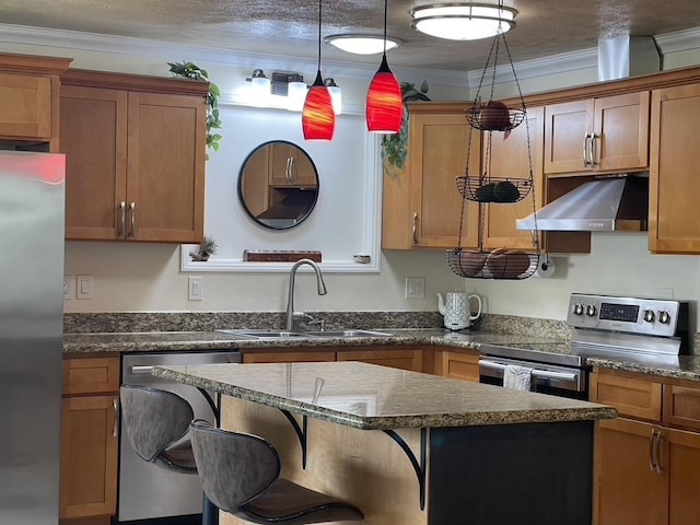 kitchen with stainless steel appliances, dark countertops, brown cabinetry, a sink, and exhaust hood