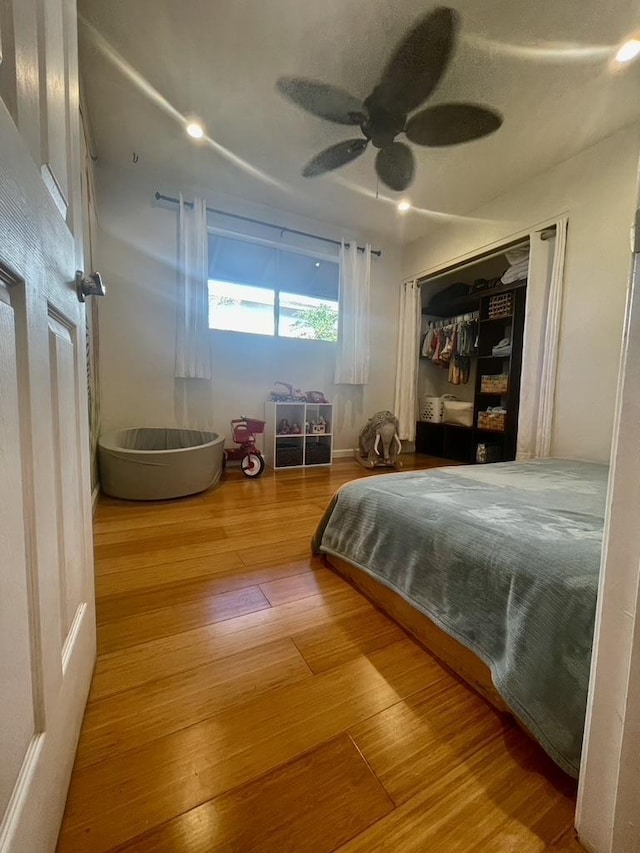 bedroom featuring a closet, a ceiling fan, and wood finished floors