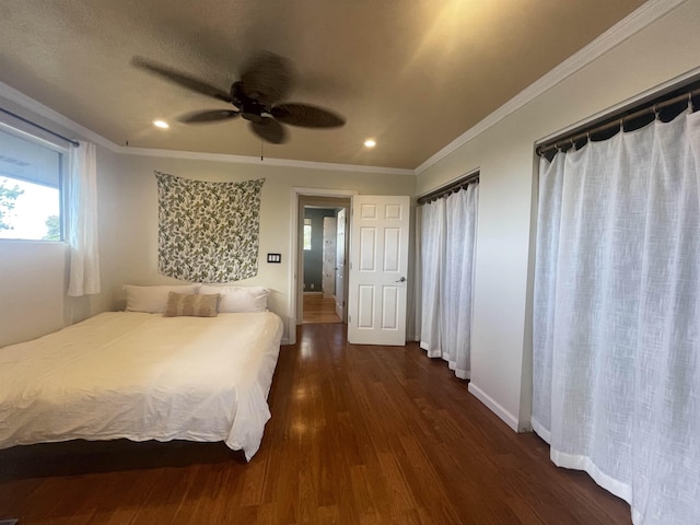 unfurnished bedroom featuring baseboards, dark wood finished floors, ceiling fan, crown molding, and recessed lighting