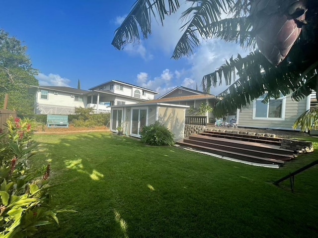 view of yard featuring a wooden deck and a sunroom