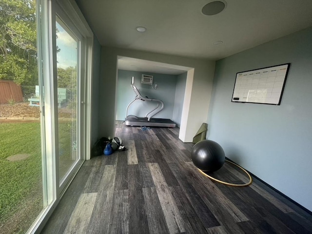 workout area featuring dark wood-style flooring