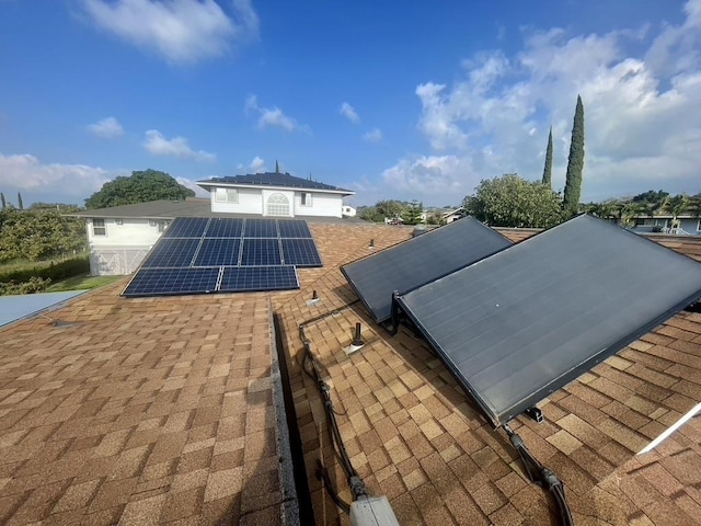 exterior space with roof with shingles