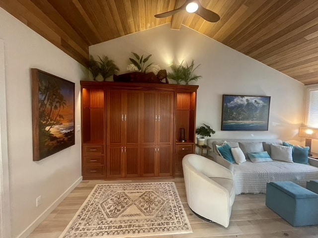 living room featuring lofted ceiling with beams, light wood-style floors, a ceiling fan, wooden ceiling, and baseboards