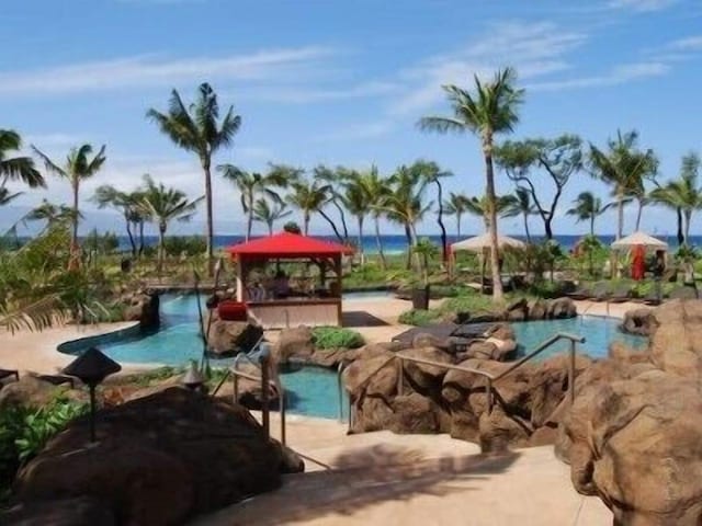 view of property's community featuring a water view and a pool