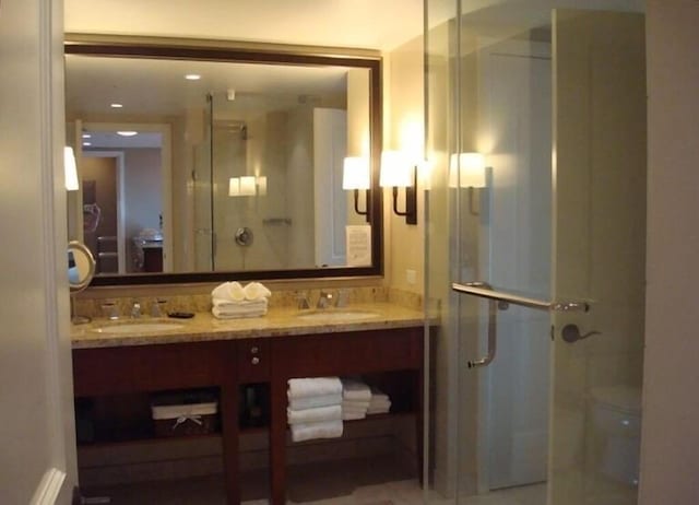 bathroom featuring vanity and an enclosed shower