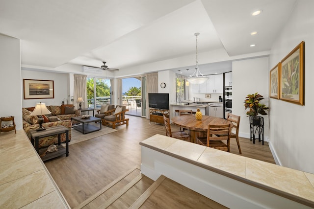 living room with sink and light hardwood / wood-style floors