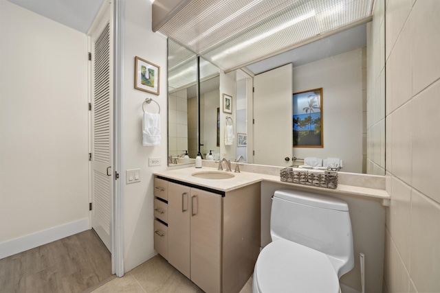 bathroom featuring vanity, hardwood / wood-style floors, and toilet