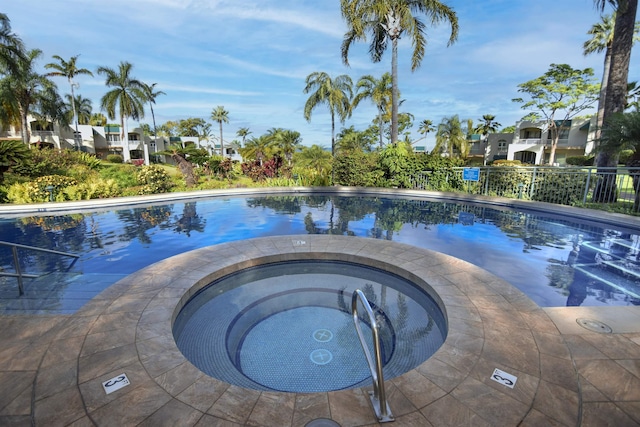 view of swimming pool with a community hot tub