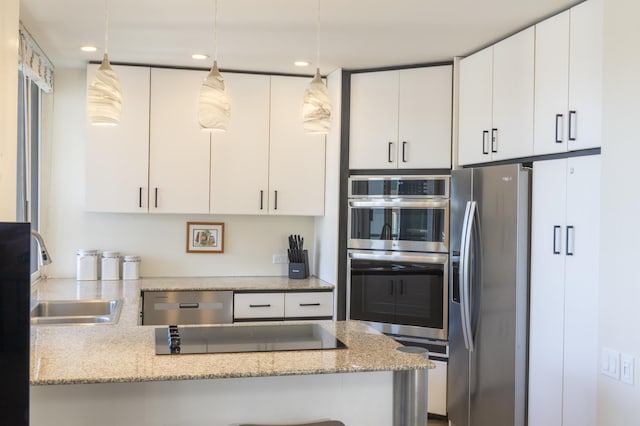 kitchen featuring sink, white cabinets, hanging light fixtures, light stone counters, and stainless steel appliances