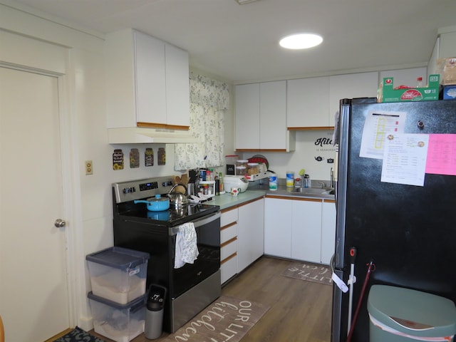 kitchen featuring dark hardwood / wood-style flooring, stainless steel appliances, and white cabinetry