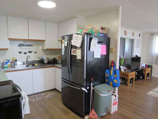 kitchen with white cabinetry, sink, black appliances, and dark hardwood / wood-style flooring