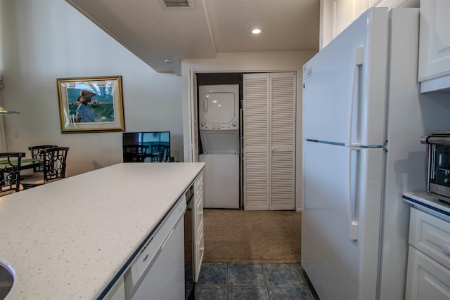 2230 S Kihei Rd Unit 9, Kihei, HI 96753 - kitchen with freestanding refrigerator, stacked washer / dryer, white cabinets, dark carpet, and recessed lighting